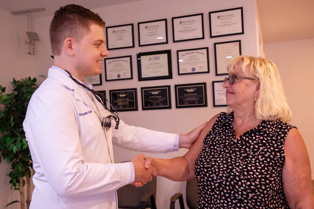 Dr. Dolecki smiling and shaking hands with a happy patient | Dentist in Punta Gorda, FL