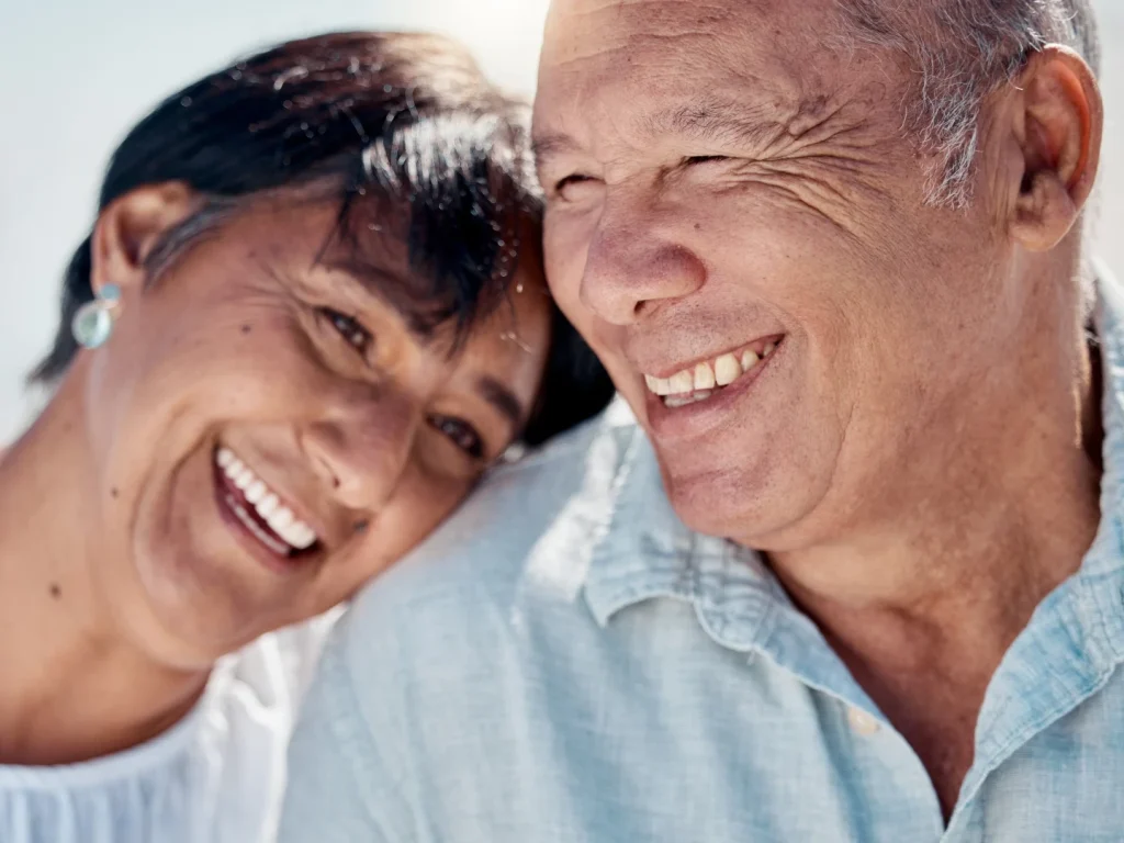 Senior couple smiling in the Florida sunshine | In-house dental membership plans in Punta Gorda, FL